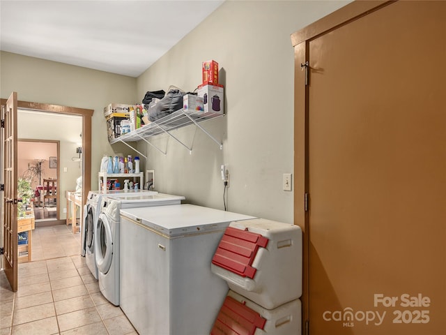 laundry room featuring washing machine and dryer, laundry area, and light tile patterned floors
