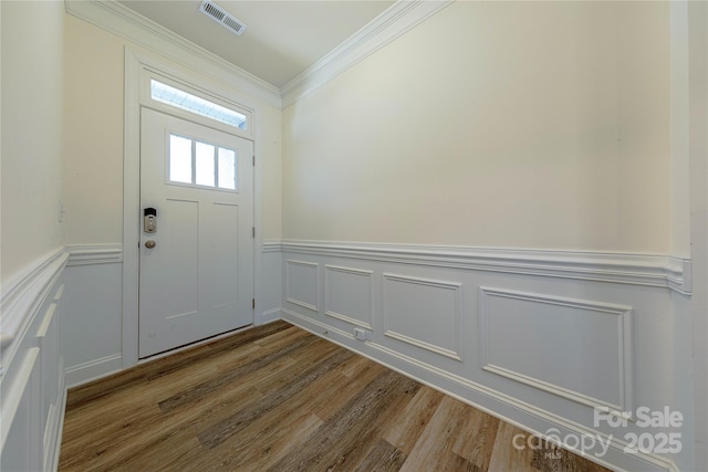 entryway with hardwood / wood-style flooring and ornamental molding