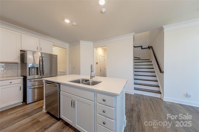 kitchen with sink, white cabinetry, stainless steel appliances, and an island with sink