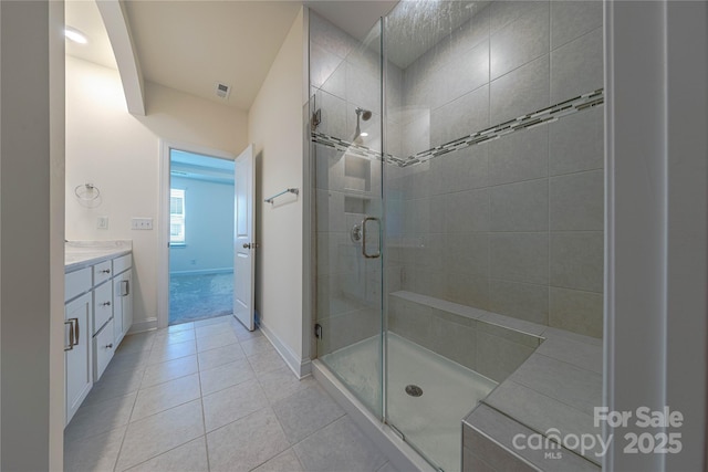 bathroom featuring tile patterned flooring, vanity, and an enclosed shower