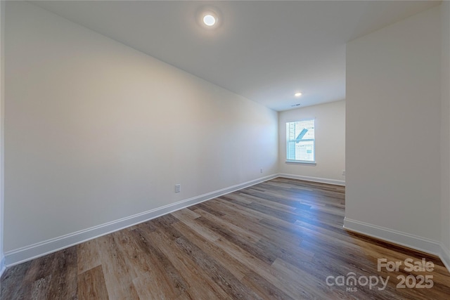 empty room with hardwood / wood-style floors