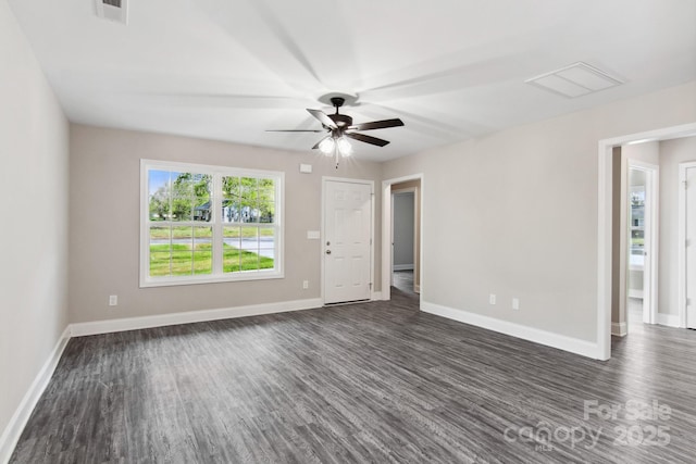 spare room featuring dark hardwood / wood-style flooring and ceiling fan