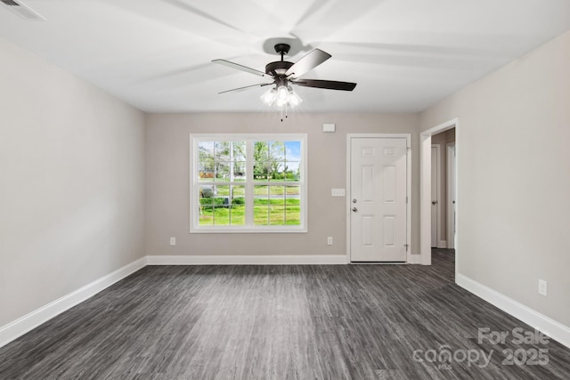 empty room with dark wood-type flooring and ceiling fan