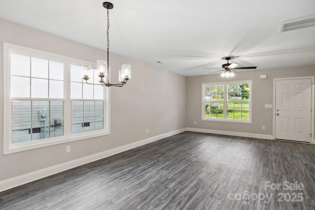 interior space with dark wood-type flooring and ceiling fan with notable chandelier