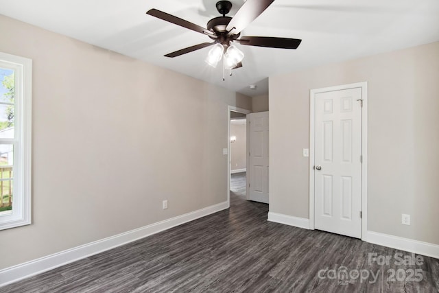 unfurnished bedroom featuring ceiling fan and dark hardwood / wood-style flooring