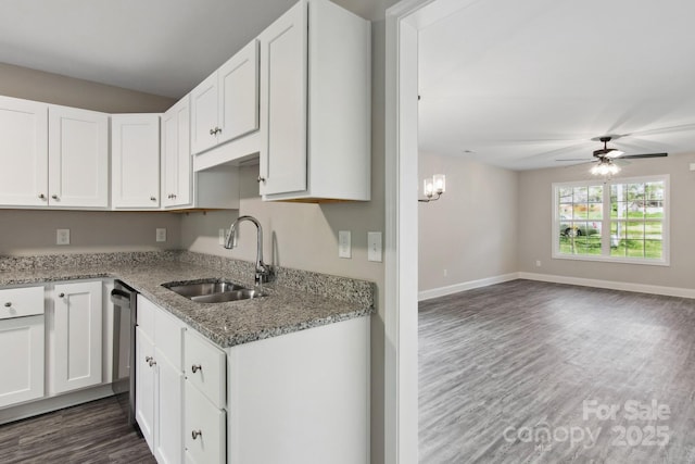 kitchen with dark wood-type flooring, sink, white cabinetry, light stone counters, and ceiling fan