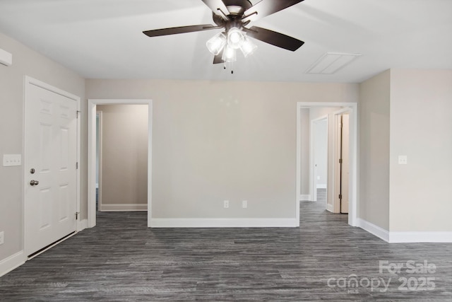 spare room with dark hardwood / wood-style flooring and ceiling fan