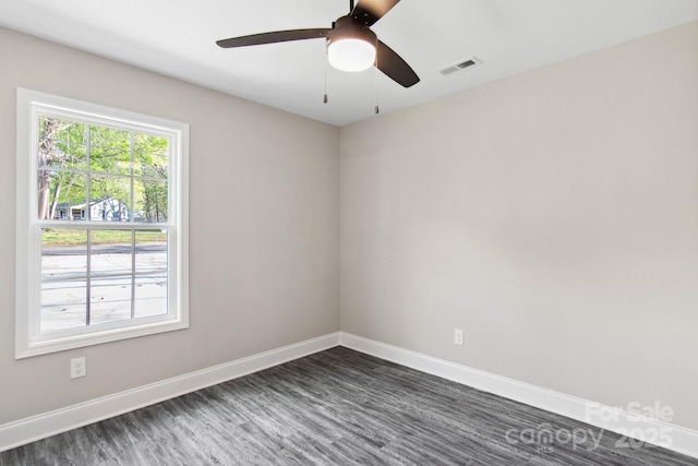 empty room featuring ceiling fan and dark hardwood / wood-style flooring