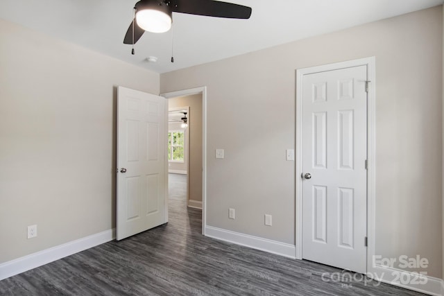 unfurnished bedroom with dark hardwood / wood-style floors and ceiling fan