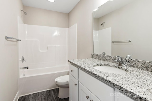 full bathroom with hardwood / wood-style flooring, shower / washtub combination, toilet, and vanity