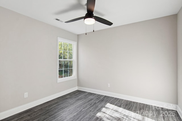 spare room featuring dark wood-type flooring and ceiling fan