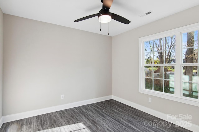 unfurnished room with dark hardwood / wood-style flooring and ceiling fan