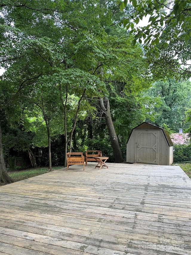 wooden terrace with a shed