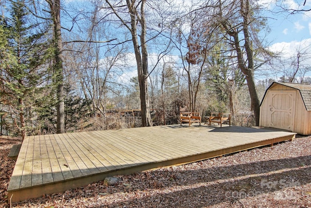 wooden terrace featuring a storage shed