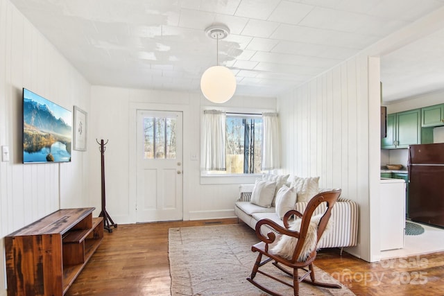 sitting room with hardwood / wood-style flooring