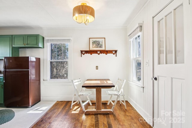 dining room with ornamental molding, dark wood-type flooring, and a notable chandelier