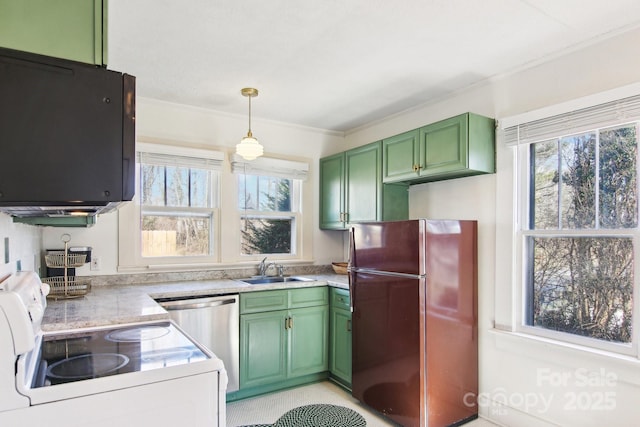 kitchen featuring refrigerator, sink, hanging light fixtures, green cabinets, and electric range