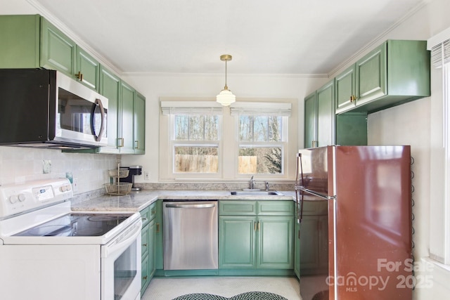 kitchen featuring stainless steel appliances, pendant lighting, sink, and green cabinets