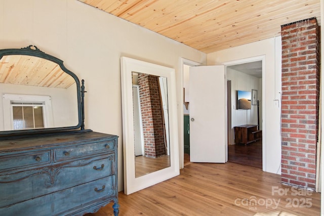 unfurnished bedroom with wood ceiling and light hardwood / wood-style flooring