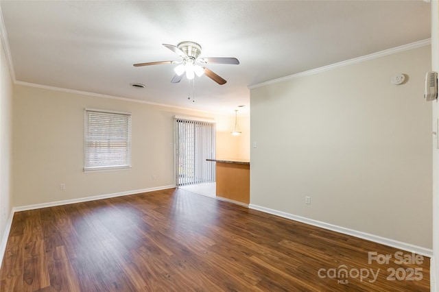 empty room with ornamental molding, dark hardwood / wood-style floors, and ceiling fan