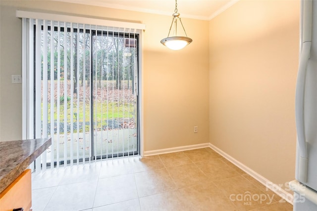 unfurnished dining area with ornamental molding and tile patterned floors