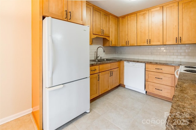 kitchen featuring sink, light tile patterned floors, backsplash, and white appliances