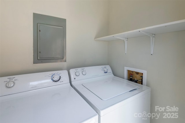 clothes washing area with electric panel and washer and clothes dryer