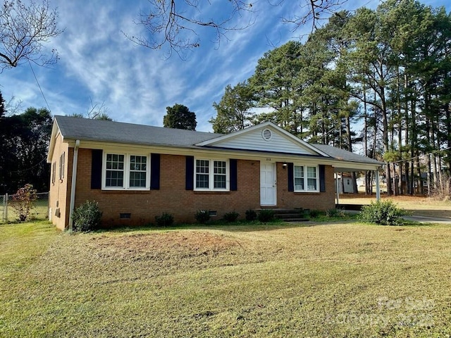 ranch-style home featuring a front yard and a carport