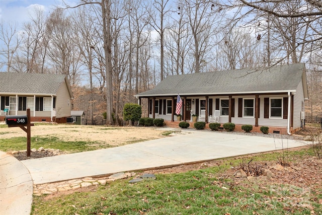 single story home with a porch and a front yard