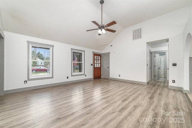 unfurnished living room with ceiling fan, high vaulted ceiling, and light wood-type flooring