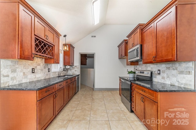 kitchen with vaulted ceiling, sink, hanging light fixtures, light tile patterned floors, and stainless steel appliances