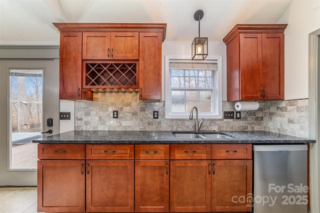 kitchen featuring hanging light fixtures, stainless steel dishwasher, sink, and a healthy amount of sunlight