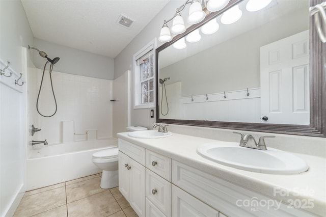 full bathroom with shower / bathing tub combination, vanity, a textured ceiling, tile patterned floors, and toilet