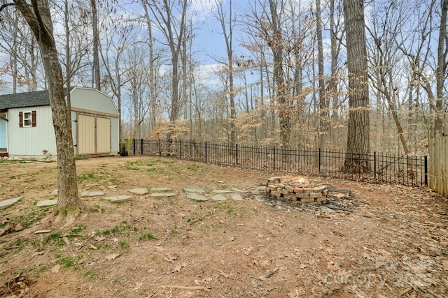 view of yard featuring a shed and a fire pit