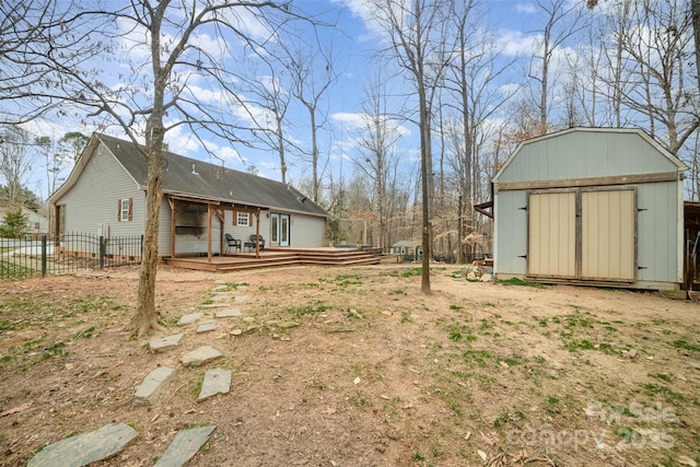 view of yard featuring a storage unit and a deck