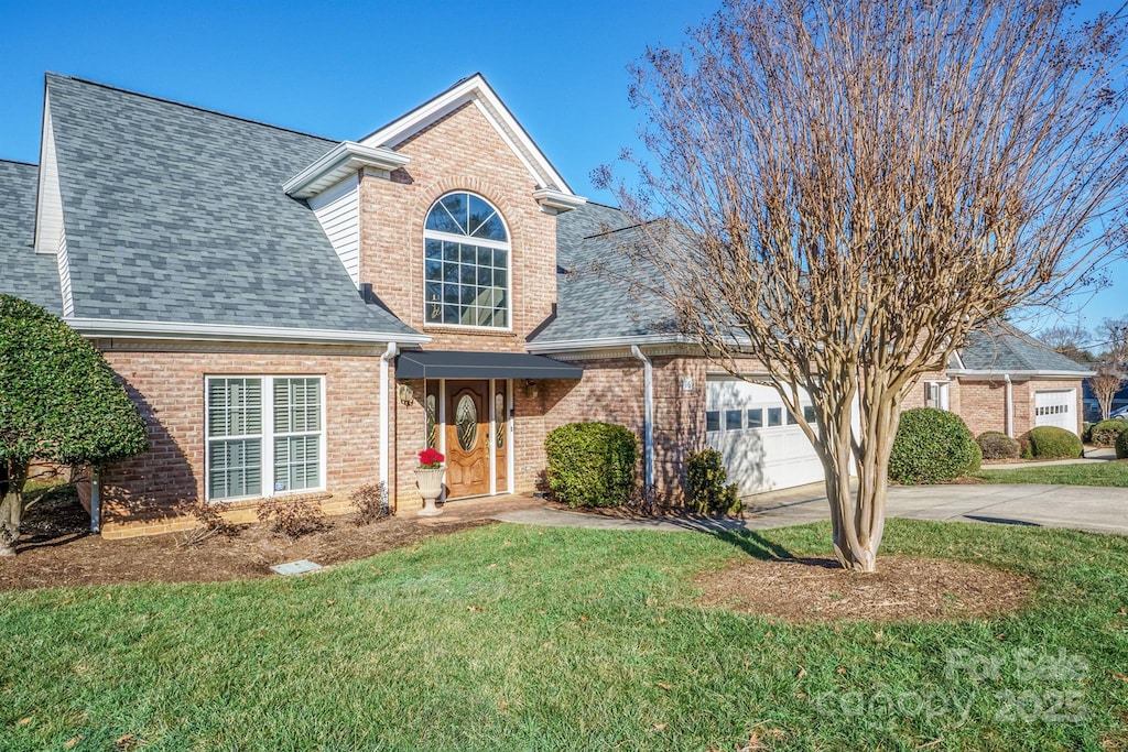 view of front property with a front lawn and a garage