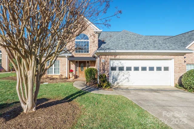 view of front of home with a front yard and a garage