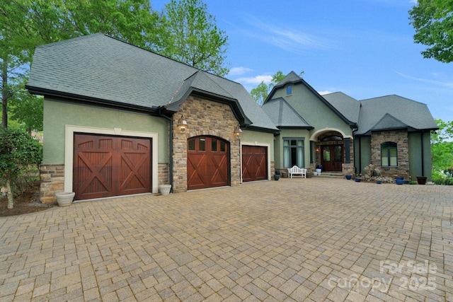 french country home with a garage