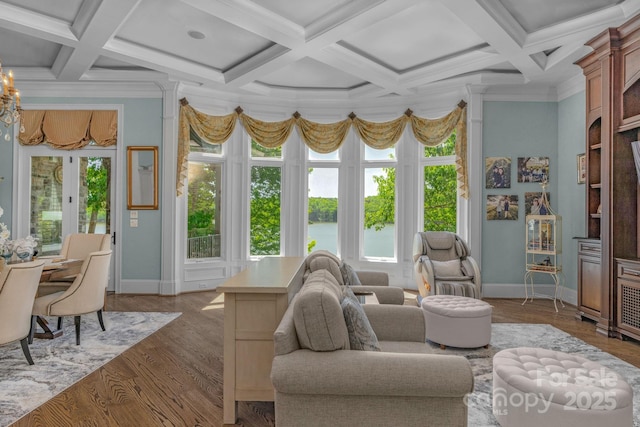 living room featuring french doors, coffered ceiling, wood-type flooring, a water view, and ornamental molding