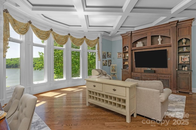 living room with coffered ceiling, crown molding, and dark wood-type flooring