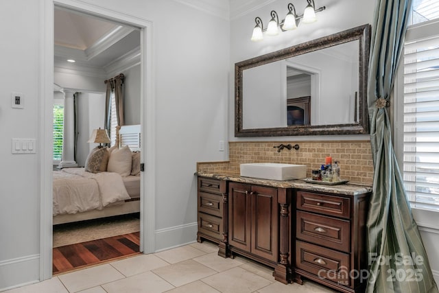 bathroom with vanity, backsplash, tile patterned floors, and ornamental molding