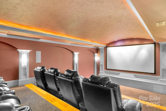 cinema room featuring brick ceiling, decorative columns, and lofted ceiling