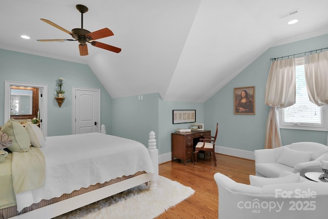 bedroom with ceiling fan, vaulted ceiling, and light hardwood / wood-style flooring