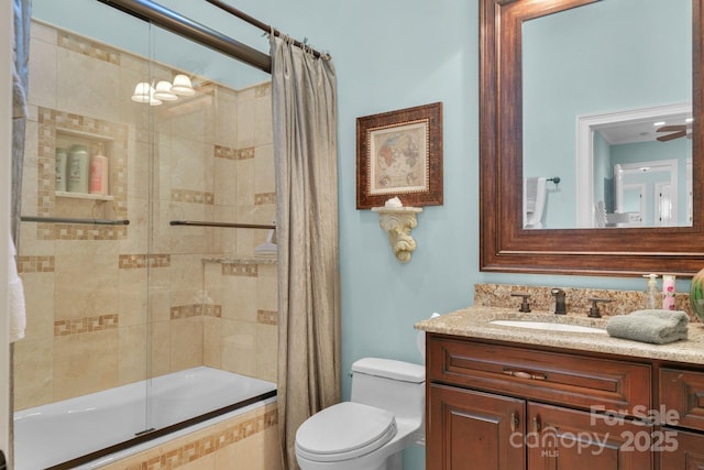 full bathroom with vanity, toilet, and enclosed tub / shower combo