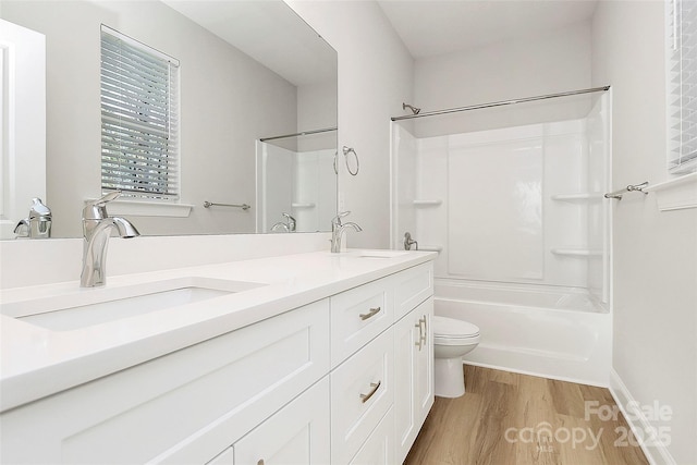 full bathroom with vanity, hardwood / wood-style flooring, bathing tub / shower combination, and toilet