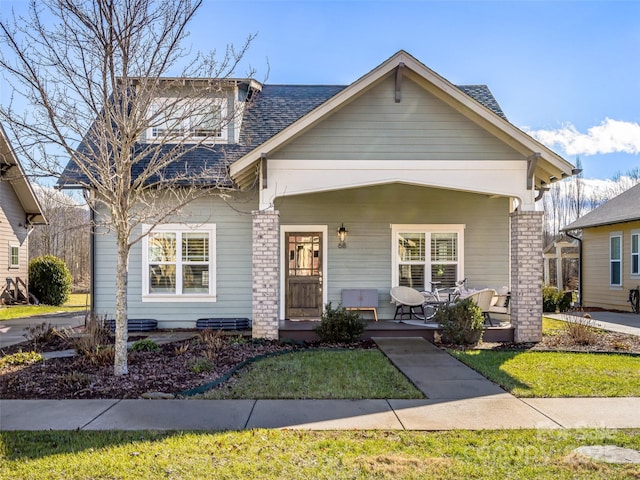 view of front of home featuring a front yard and a porch