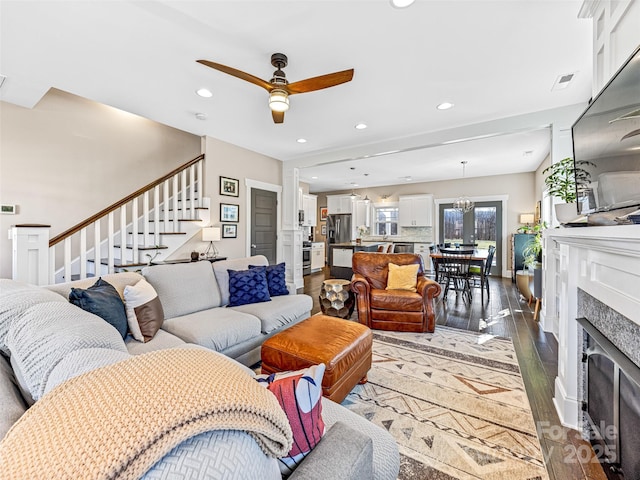 living room featuring ceiling fan, dark hardwood / wood-style flooring, and a high end fireplace