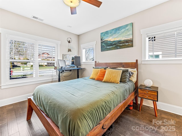 bedroom with ceiling fan and dark hardwood / wood-style floors