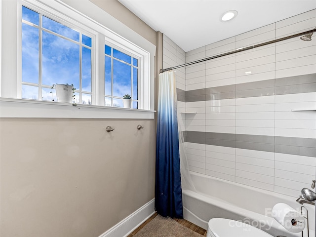 bathroom featuring shower / tub combo with curtain, wood-type flooring, plenty of natural light, and toilet