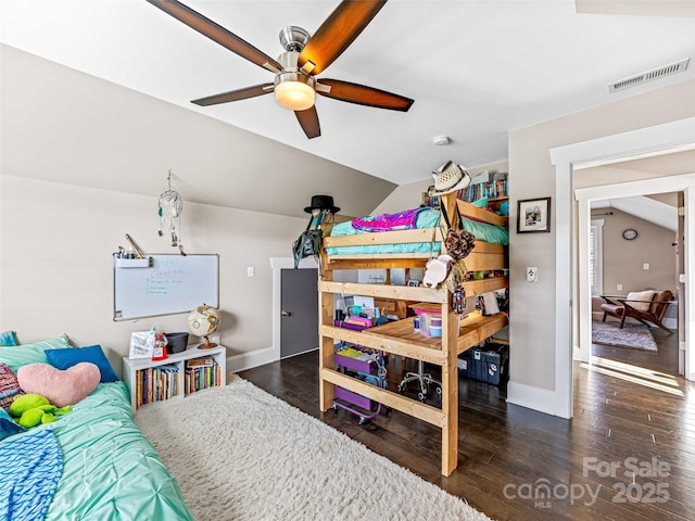 bedroom featuring ceiling fan, dark wood-type flooring, and vaulted ceiling